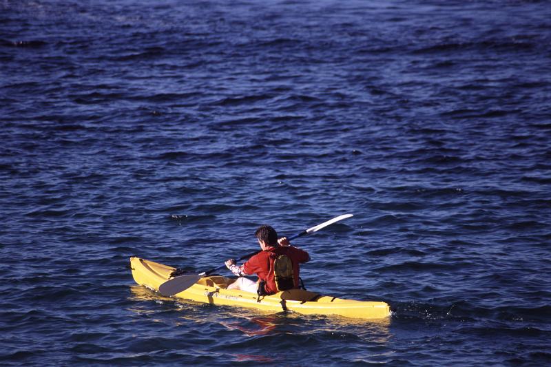 Free Stock Photo: a man paddling through the water on a yellow ocean kayak