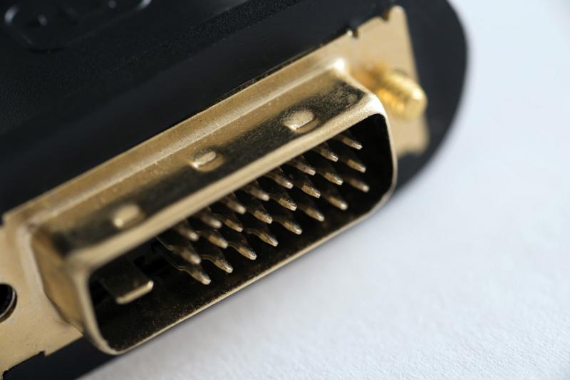 Free Stock Photo: Detail view of DVI video connector with yellow metal or gilded pins close-up on white surface with copy space