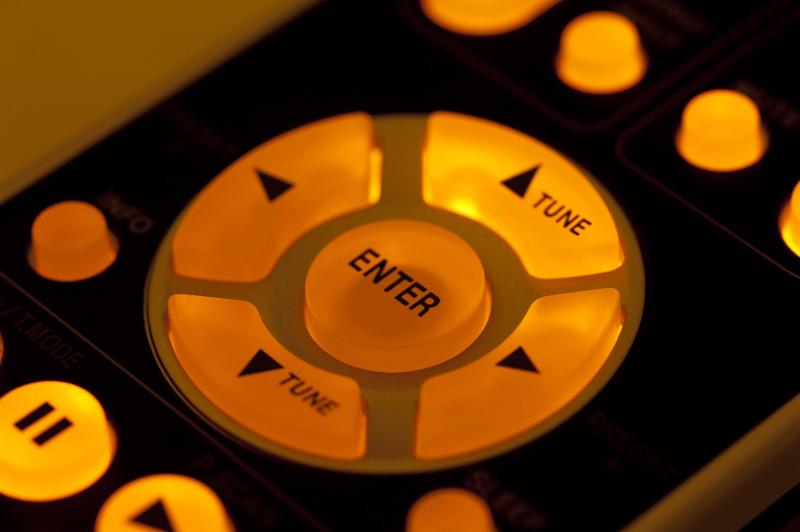 Free Stock Photo: Yellow glowing backlit buttons of remote control, close-up cropped image of arrows and Enter button