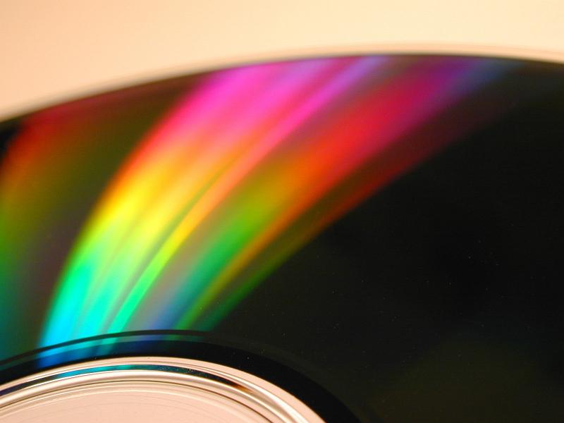 Free Stock Photo: Spectrum rainbow light reflection on CD or DVD optical disc radial surface, as digital object beauty background concept