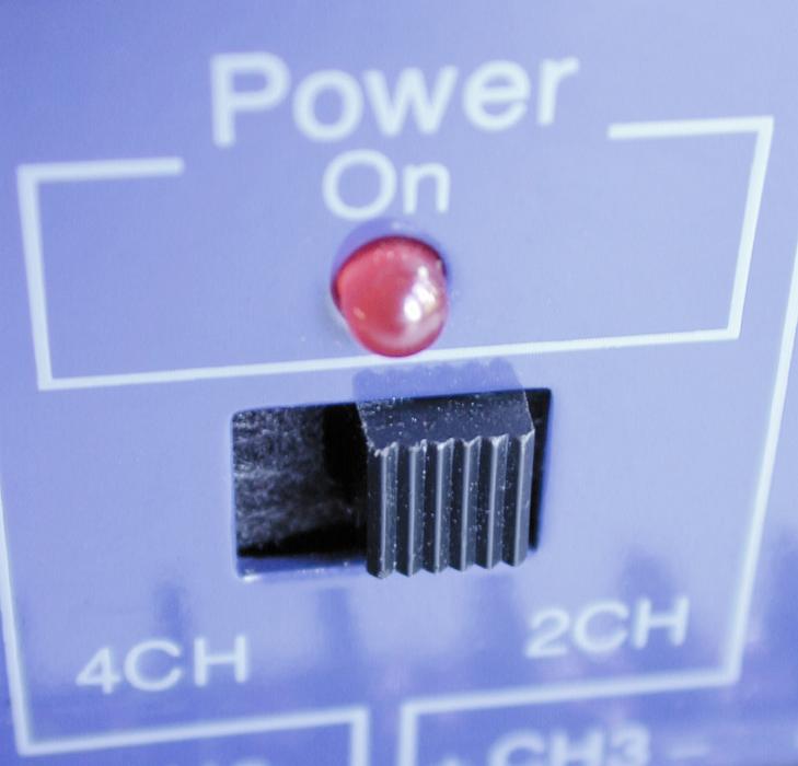 Free Stock Photo: Power slider with a red light below on blue electronic equipment in a close up view with focus to the switch