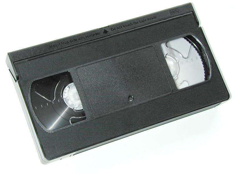 Free Stock Photo: Old black plastic video cassette tape with no label isolated on white in an entertainment and communication concept