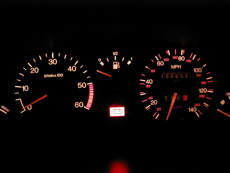 Free Stock Photo: Close up on automobile dashboard lights with tachometer and speedometer. Fuel guage at empty with battery light on.