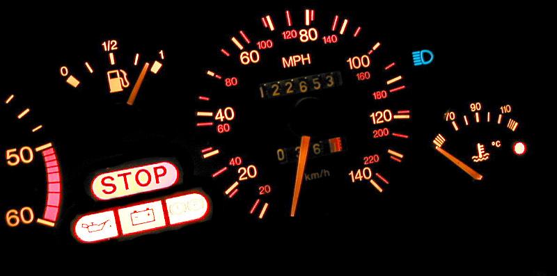 Free Stock Photo: Close up on back lit dashboard display for automobile. Includes fuel gauge and other readouts.