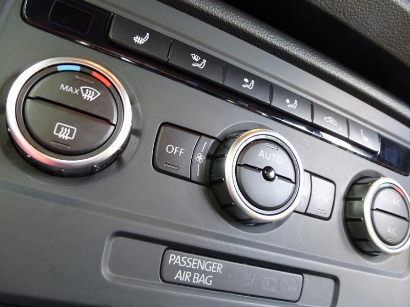 Free Stock Photo: Assorted controls on a car dashboard with the defrost knob, passenger airbag, air vent and conditioning controls, heating and cooling