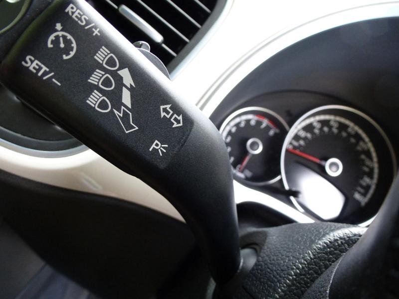 Free Stock Photo: Close up of car light lever on steering wheel with speedometer and fuel gauge in the background