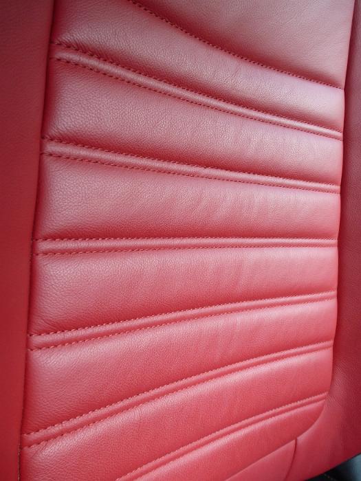 Free Stock Photo: Red leather texture in a vehicle interior showing the ridges seat support at an oblique angle in a modern luxury car