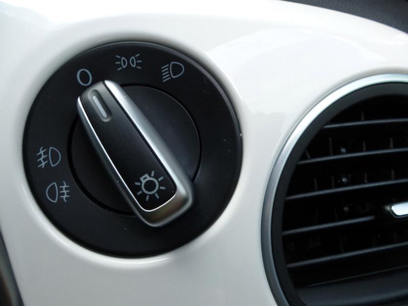 Free Stock Photo: Car light switch on a dashboard of a white car with controls for full beam and parking lights