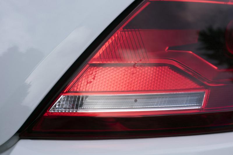 Free Stock Photo: Close up detail of a car rear or tail light showing the red brake lens and clear indicator strip