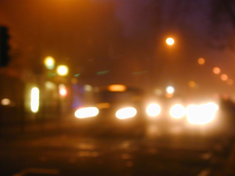 Free Stock Photo: Blurry street scene at night with bright streetlights and headlights from various vehicles