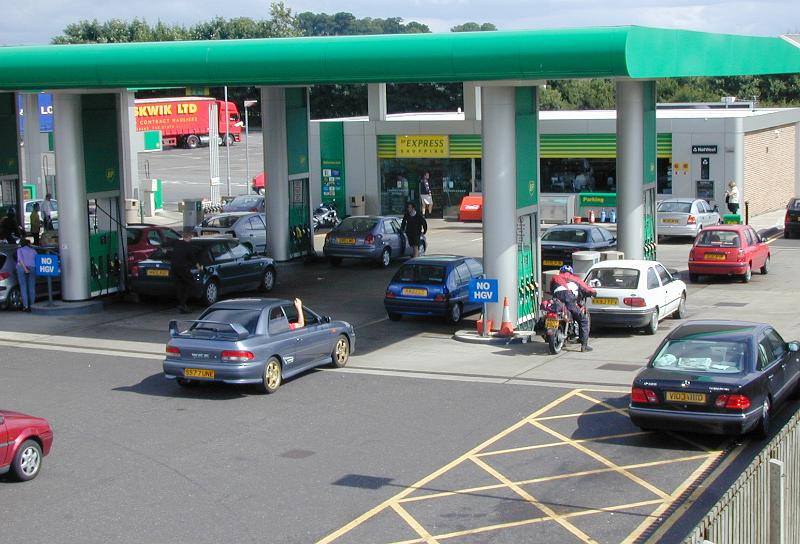 Free image of Motorists waiting for petrol in a forecourt