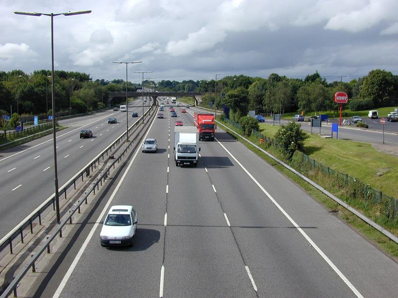 Free Stock Photo: Cars and trucks driving on a multi lane freeway approaching the camera taken from a high angle perspective on a bridge