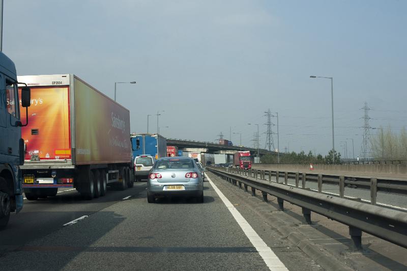 Free Stock Photo: Car and trucks driving on a freeway taken from behind in the perspective of the driver of a following car