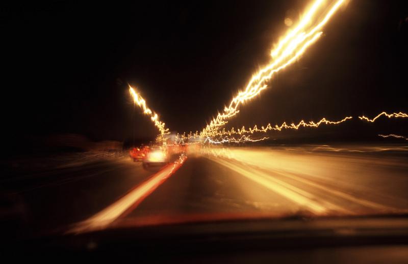 Free Stock Photo: View from inside moving car of wavy streetlights and headlights from other vehicles with copy space