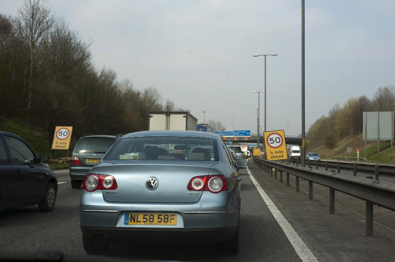 Free Stock Photo: Cars caught in a motorway tailback or traffic jam viewed from a drivers perspective with a center barricade on the right