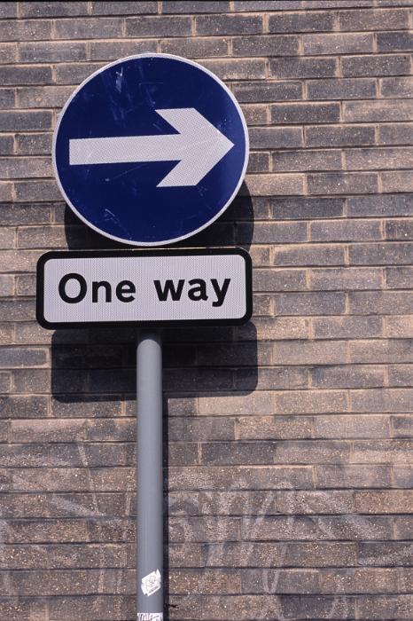 Free Stock Photo: One Way street or traffic sign and uni directional arrow pointing to the right against an urban brick wall with copy space
