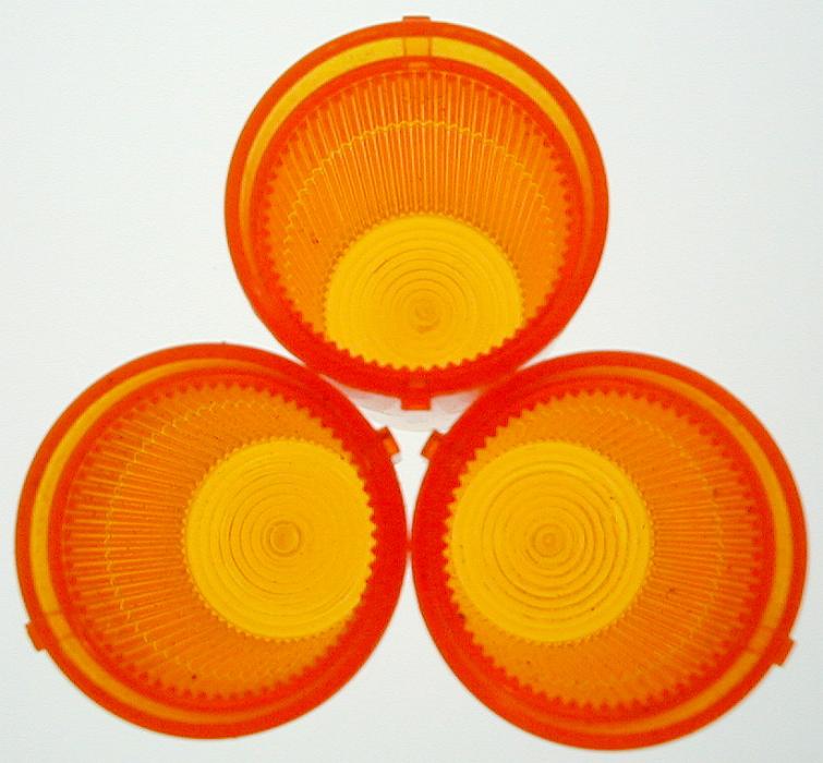 Free Stock Photo: Three round orange filters or plastic lenses for car lights and indicators isolated on white
