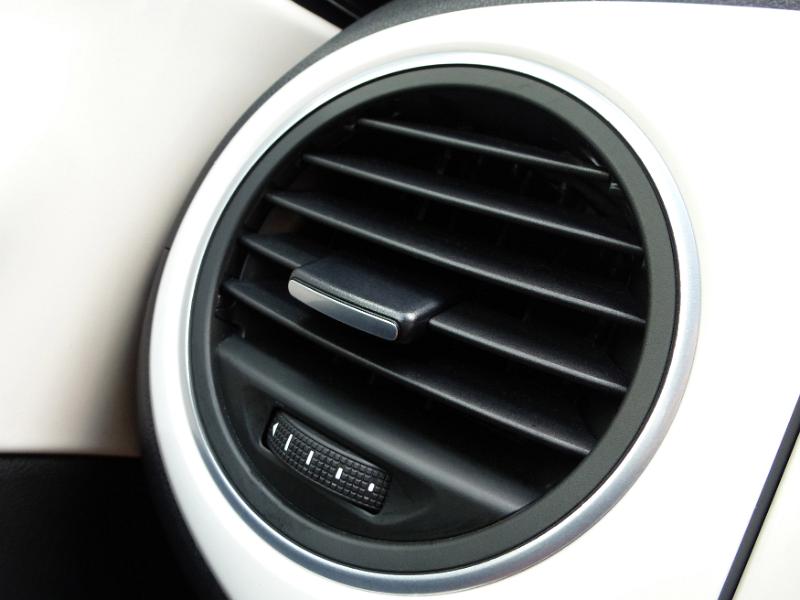 Free Stock Photo: Air vent on the side of a dashboard on a white car in a close up automotive detail