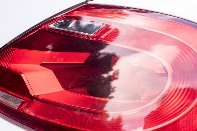 Free Stock Photo: Close up detail of a red lens on a tail light of a modern white car showing the construction of the unit