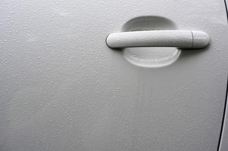 Free Stock Photo: White handle on a car door with beads of moisture from rain or dew and copy space