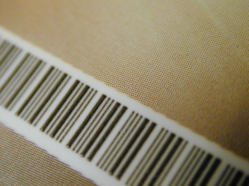 Free Stock Photo: Bar code with product information for identification on brown textured paper in a diagonal full frame view