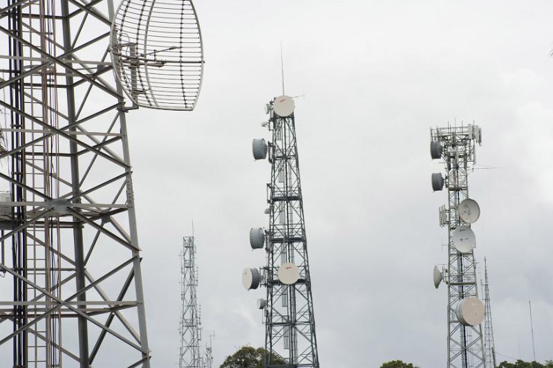 Free Stock Photo: Series of communications towers with antennae for mobile phones on a grey cloudy today