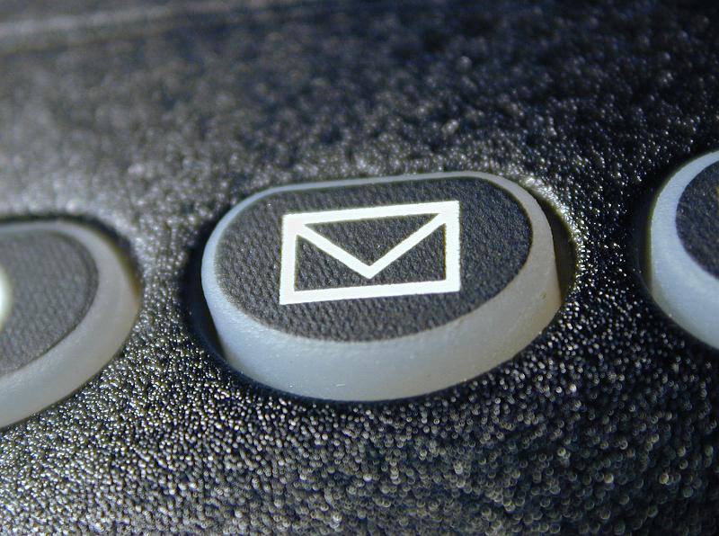 Free Stock Photo: Envelope mail or message icon on a black keypad with buttons on a retro telephone or cellphone in a communication concept