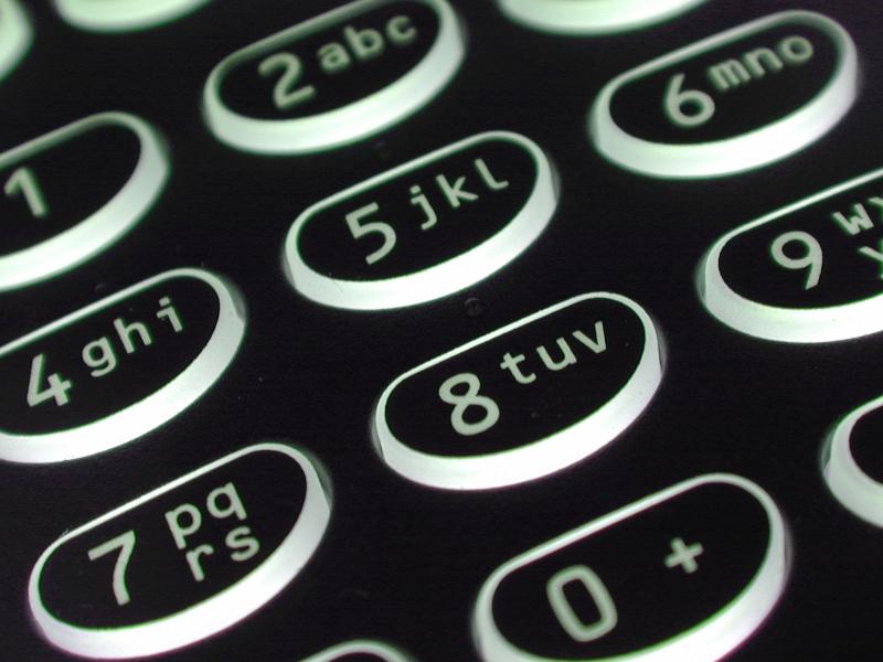 Free Stock Photo: Alphanumeric button keypad with numerals and letters on an old black mobile phone in a close up view