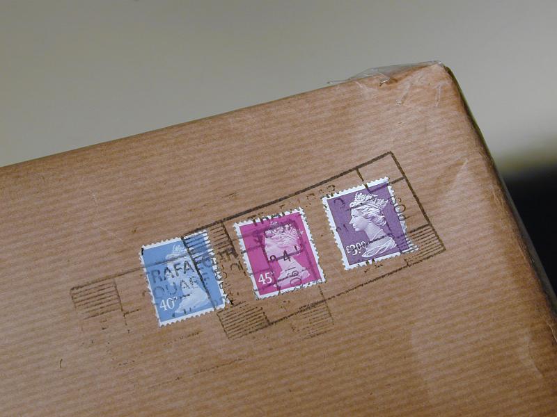 Free Stock Photo: Cancelled British stamps for payment of postage on a brown paper parcel sent by Royal Mail