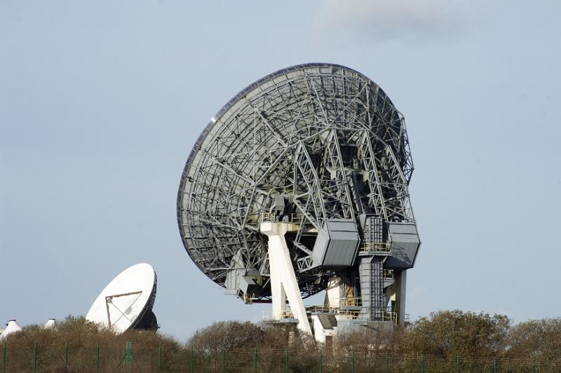Free Stock Photo: Large parabolic ground station satellite telecommunication dishes on a hilltop on the skyline viewed from the rear