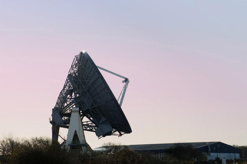 Free Stock Photo: Silhouette of a satellite ground dish or parabolic antenna at sunrise or sunset against a colorful pink sky with copy space in a communications concept