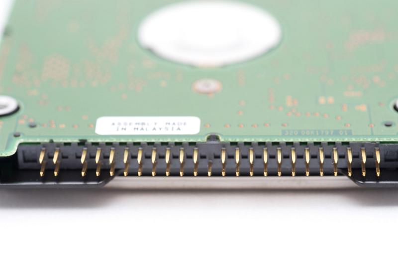Free Stock Photo: Parallel ATA, PATA disk connector in close-up selective focus view with HDD circuit board visible in blur