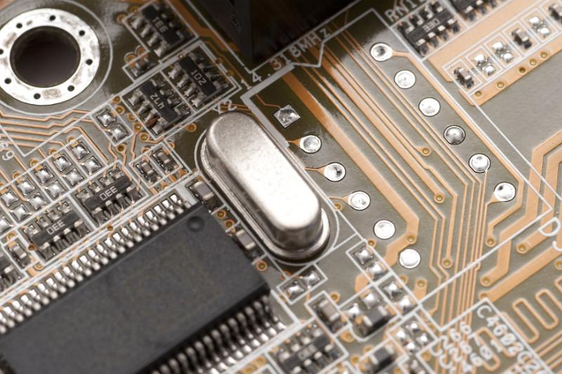 Free Stock Photo: Close up detail on printed circuit board with resistors, capacitors, microprocessors and speaker