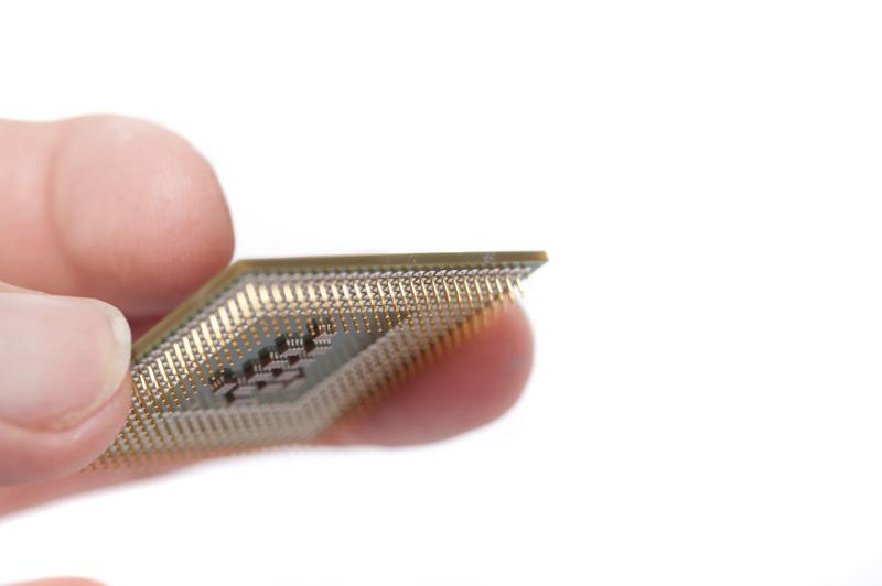 Free Stock Photo: Fingers holding cpu computer processor chip with pins shown