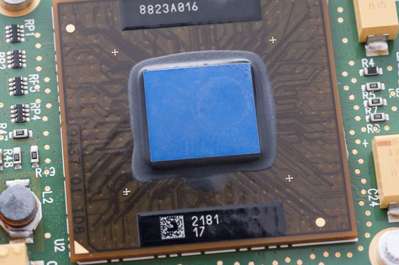 Free Stock Photo: Close up on microprocessor chip covered with thin plastic layer on a printed circuit board inside laptop computer