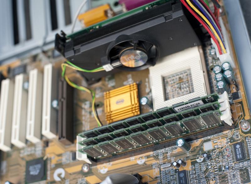 Free Stock Photo: Close up of an old style electronic computer motherboard and cooling fan.