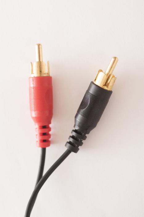Free Stock Photo: Close up of two red and black RCA audio cable connections, isolated on a plain white background.