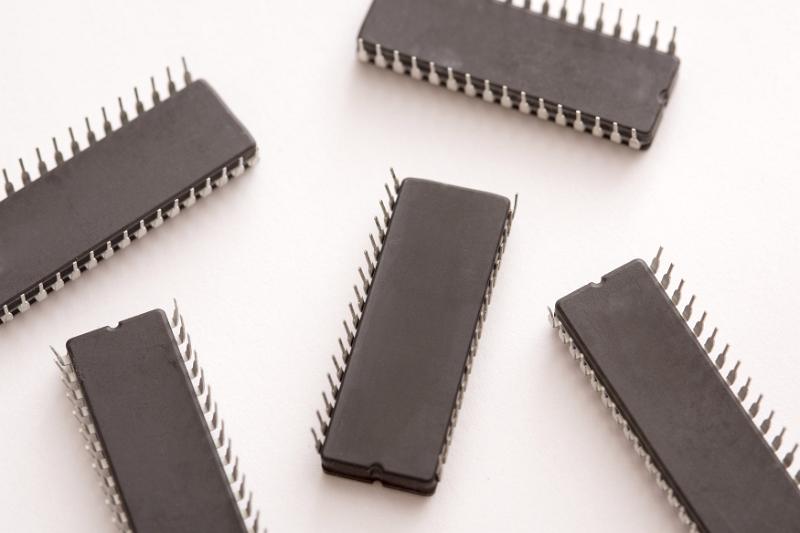 Free Stock Photo: Five upside down integrated circuit computer chips isolated on a white background with copy space.