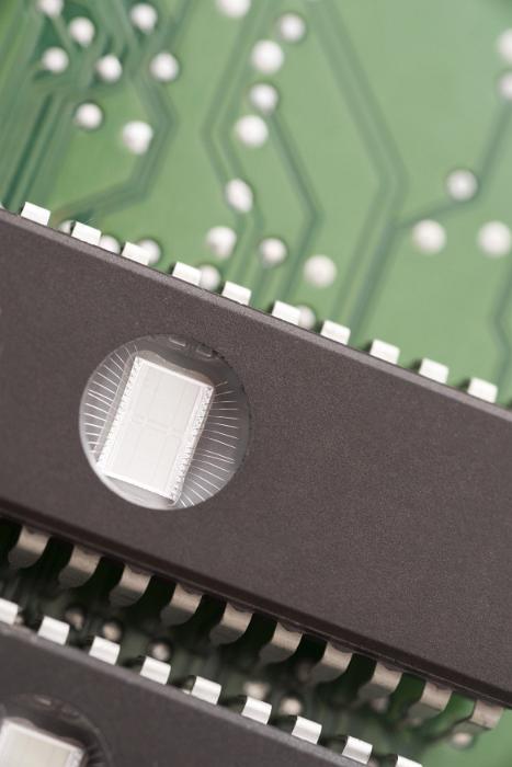 Free Stock Photo: EPROM memory chips with round windows on black backs, installed on green electronic printed circuit board, close-up cropped image with copy space