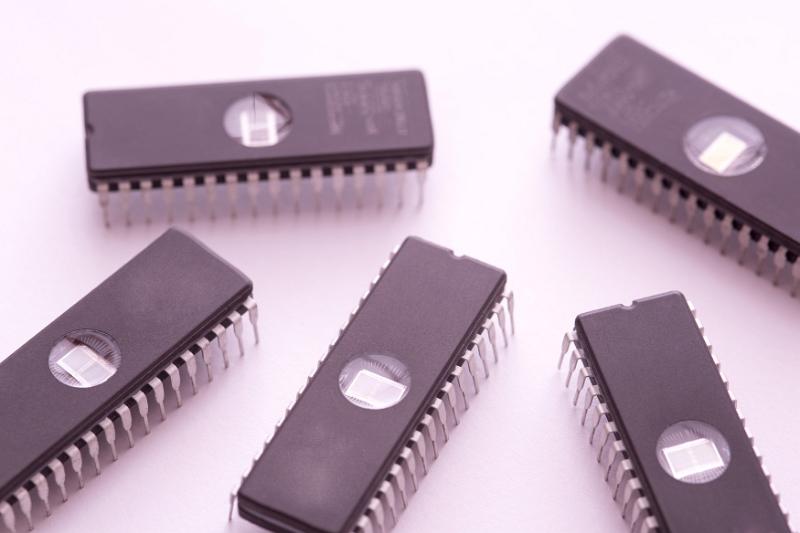 Free Stock Photo: Five integrated circuit components scattered and isolated on a plain white background.