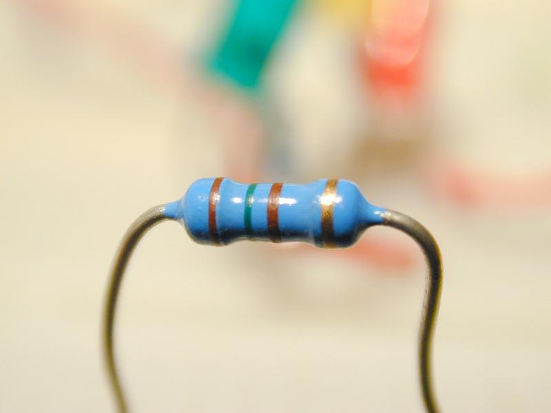 Free Stock Photo: Close up of a blue electronic resistor, isolated on a blurred background.