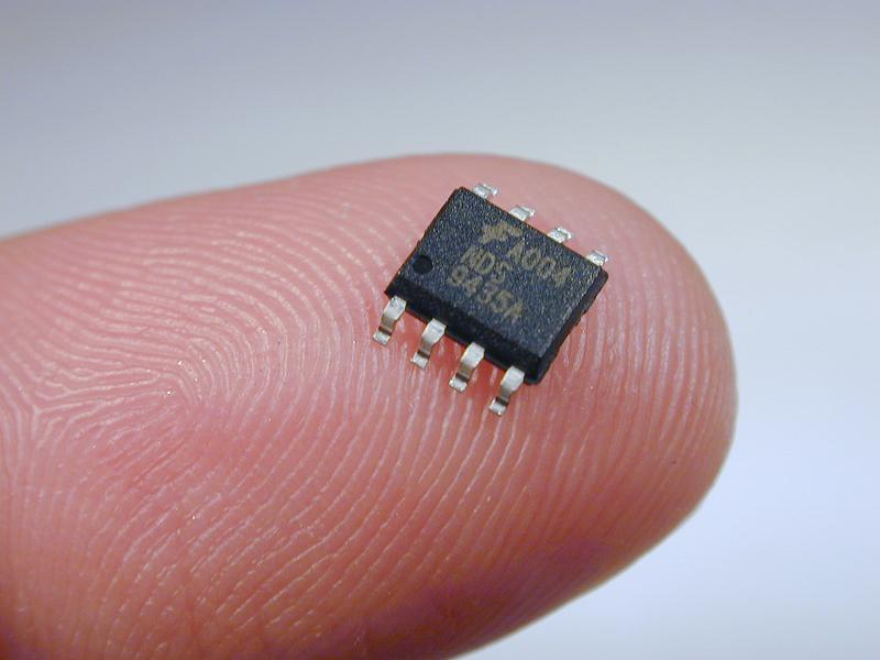 Free Stock Photo: tiny surface mount integrate circuit on a finger tip