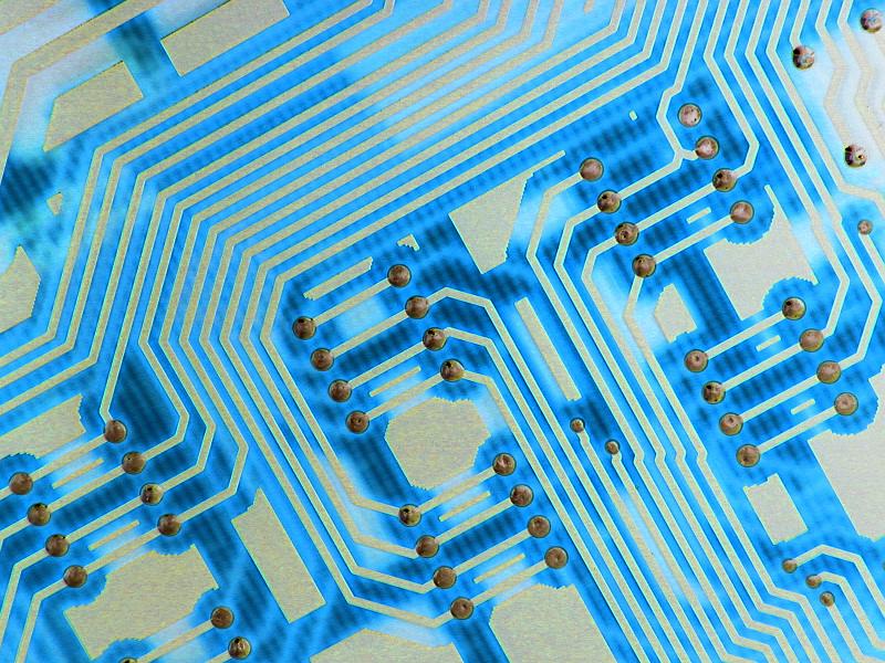 Free Stock Photo: Close up, abstract angle of the fluorescent blue wiring and conductive tracks of a computer circuit board.