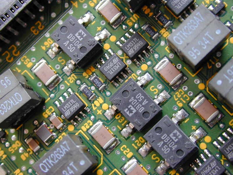 Free Stock Photo: Close up of diode rectification, transformer and transistor electrical components on a green circuit board.