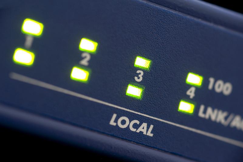 Free Stock Photo: green data lights on the front of an ethernet router
