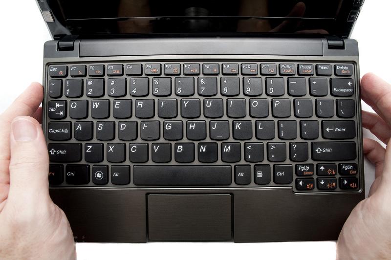 Free Stock Photo: hands holding a small netbook computer