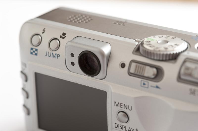 Free Stock Photo: Close up view on the dials, controls and display of a silver digital point and shoot compact camera over a white background