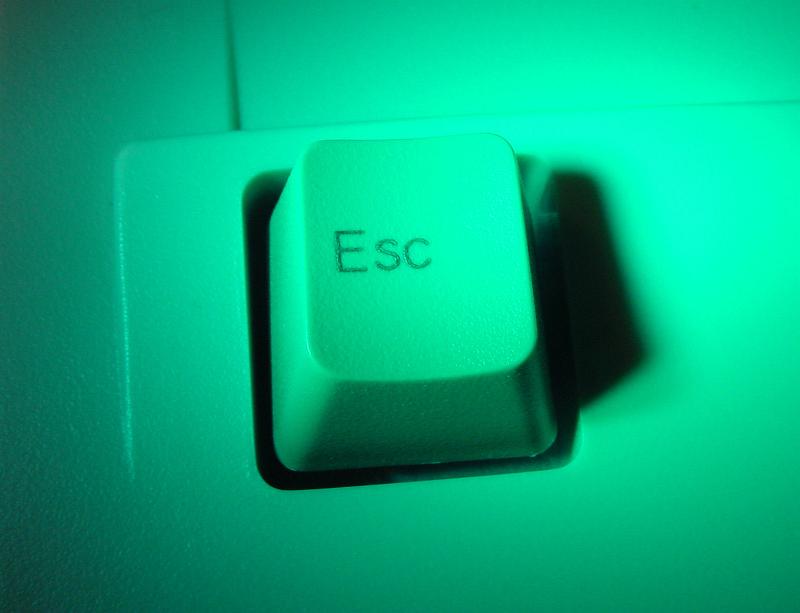 Free Stock Photo: Close up view of a white computer Escape key in green light in a computing and communications concept