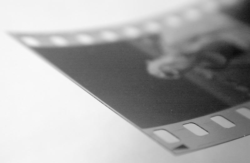 Free Stock Photo: End of exposed 35mm negative film on studio background with copy space