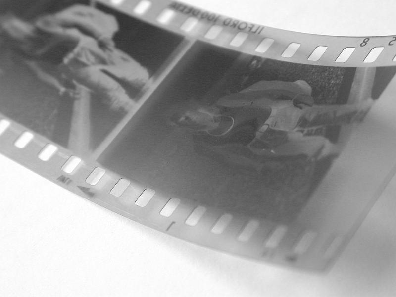Free Stock Photo: Close up of an exposed 35mm negative film strip with frames of a person and sprocket detail in a photography concept